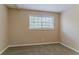 Bright bedroom featuring neutral walls and carpet, plus a well-lit window at 2212 Chestnut Log Loop, Lithia Springs, GA 30122