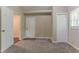 Bedroom featuring carpeted floors, a door, and a closet, with neutral walls at 2212 Chestnut Log Loop, Lithia Springs, GA 30122
