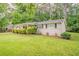 Inviting home exterior showcasing a lush green lawn and well-maintained landscaping at 2212 Chestnut Log Loop, Lithia Springs, GA 30122