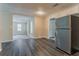 Spacious kitchen with stainless steel appliances, wood-look flooring, and an adjacent living area at 2212 Chestnut Log Loop, Lithia Springs, GA 30122