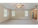 Living room with neutral walls, carpeted floors, and natural light from multiple windows at 2212 Chestnut Log Loop, Lithia Springs, GA 30122