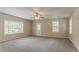 Spacious living room with natural light, neutral walls, and carpeted floors at 2212 Chestnut Log Loop, Lithia Springs, GA 30122