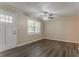 Inviting living room featuring hardwood floors, a bright window, and a ceiling fan at 2212 Chestnut Log Loop, Lithia Springs, GA 30122