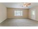 Well-lit living room with neutral walls, carpet, and a bay window at 2212 Chestnut Log Loop, Lithia Springs, GA 30122