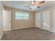 This spacious main bedroom is well-lit and includes two closets and fan at 2212 Chestnut Log Loop, Lithia Springs, GA 30122