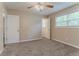Spacious main bedroom featuring neutral walls, new carpet, fan and closet doors at 2212 Chestnut Log Loop, Lithia Springs, GA 30122
