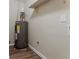 Well-maintained water heater with an expansion tank on a wood-look floor and a white wall with an outlet at 2212 Chestnut Log Loop, Lithia Springs, GA 30122
