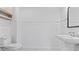 Clean and bright bathroom featuring a pedestal sink and paneled walls at 4978 Thornwood Nw Cv, Acworth, GA 30102