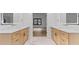 Bright bathroom with double vanity sinks, marble counters, and stylish gold fixtures at 4978 Thornwood Nw Cv, Acworth, GA 30102