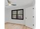 Bright bedroom with hardwood floors, ceiling fan, and a window overlooking the surrounding trees at 4978 Thornwood Nw Cv, Acworth, GA 30102