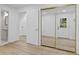 Bedroom features mirrored closet doors, hardwood floors, and a doorway to a bathroom at 4978 Thornwood Nw Cv, Acworth, GA 30102