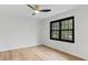 Bright bedroom with modern ceiling fan, a large window, and light wood flooring at 4978 Thornwood Nw Cv, Acworth, GA 30102
