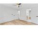 Bright bedroom with modern ceiling fan, light wood flooring, and view to the bathroom at 4978 Thornwood Nw Cv, Acworth, GA 30102