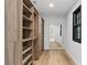 Large walk-in closet featuring custom shelving and storage, with hardwood floors and natural light at 4978 Thornwood Nw Cv, Acworth, GA 30102