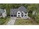 Two-story home featuring a two-car garage, white stucco exterior, and a beautifully landscaped front yard at 4978 Thornwood Nw Cv, Acworth, GA 30102