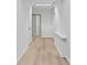 A bright hallway with light hardwood floors leads to a bathroom and bedroom at 4978 Thornwood Nw Cv, Acworth, GA 30102