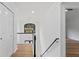 Bright hallway on second floor features hardwood floors, overhead lighting and chandelier at 4978 Thornwood Nw Cv, Acworth, GA 30102