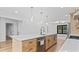 Kitchen with wood cabinets, white countertops, and a kitchen island with a built-in dishwasher at 4978 Thornwood Nw Cv, Acworth, GA 30102