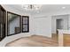 Bright living room features hardwood floors, modern light fixture, and large windows at 4978 Thornwood Nw Cv, Acworth, GA 30102