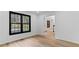 Bright room with wood floors, a large window, and white trim at 4978 Thornwood Nw Cv, Acworth, GA 30102