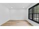 Bright, airy room with wood floors and a large window offering natural light at 4978 Thornwood Nw Cv, Acworth, GA 30102