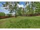 Expansive backyard with lush greenery, mature trees, and privacy fencing at 509 Orchards Walk, Stone Mountain, GA 30087