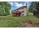 Back exterior view of home with a spacious lawn and an elevated deck for outdoor enjoyment at 509 Orchards Walk, Stone Mountain, GA 30087