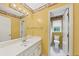 Bright bathroom with a large mirror, modern sink, and a toilet, enhanced by natural light at 509 Orchards Walk, Stone Mountain, GA 30087