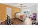 Bedroom featuring hardwood floors, a queen bed, and a bright window at 509 Orchards Walk, Stone Mountain, GA 30087