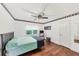 Relaxing bedroom with a queen bed, wood floors, and a ceiling fan for a comfortable retreat at 509 Orchards Walk, Stone Mountain, GA 30087