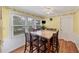 Sun-filled breakfast nook features a square table, large windows, and hardwood floors at 509 Orchards Walk, Stone Mountain, GA 30087