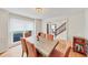 Well-lit dining room offering a view of the stairway, wood floors, and seating for six at 509 Orchards Walk, Stone Mountain, GA 30087