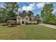 Inviting two-story home boasting a manicured front lawn, lush plantings, and a long, paved driveway at 509 Orchards Walk, Stone Mountain, GA 30087