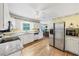 Bright eat-in kitchen boasts white cabinets, granite countertops, stainless steel appliances, and hardwood floors at 509 Orchards Walk, Stone Mountain, GA 30087