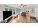 Open living room with hardwood floors, natural light, and a glimpse into the modern kitchen at 509 Orchards Walk, Stone Mountain, GA 30087