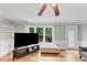 Bright living room with hardwood floors, large windows with backyard views, and built-in bookshelves at 509 Orchards Walk, Stone Mountain, GA 30087