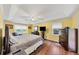 Bright main bedroom featuring hardwood floors, tray ceilings, and recessed lighting at 509 Orchards Walk, Stone Mountain, GA 30087