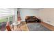 Cozy sitting room featuring a futon and a large window providing natural light at 509 Orchards Walk, Stone Mountain, GA 30087