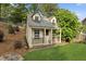 Backyard playhouse with a charming design, small porch, and lush greenery at 230 Bluff Oak Dr, Roswell, GA 30076