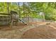 Backyard playground area with a swing set, slide, and wooden fence at 230 Bluff Oak Dr, Roswell, GA 30076