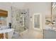 Modern bathroom with soaking tub, glass walk-in shower, backlit mirrors, and stylish fixtures at 230 Bluff Oak Dr, Roswell, GA 30076