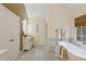Bright bathroom showcases a soaking tub, modern vanity, storage, and luxurious white finishes at 230 Bluff Oak Dr, Roswell, GA 30076