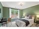 Bright bedroom features large window, green walls, and carpeted floors at 230 Bluff Oak Dr, Roswell, GA 30076