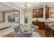 Cozy dining area features a glass table, seating for four, and seamless flow into the adjacent living room at 230 Bluff Oak Dr, Roswell, GA 30076