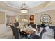 Formal dining room with a tray ceiling, large window, and plenty of space for entertaining guests at 230 Bluff Oak Dr, Roswell, GA 30076