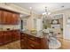 Stylish kitchen with an island, granite countertops, wooden cabinets, and an open layout to the living room at 230 Bluff Oak Dr, Roswell, GA 30076