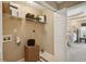 Bright laundry room with overhead shelving, washer and dryer hookups, and access to a bedroom at 230 Bluff Oak Dr, Roswell, GA 30076