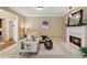 Comfortable living room with fireplace, neutral tones, and an open layout connecting to the kitchen at 230 Bluff Oak Dr, Roswell, GA 30076