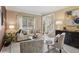 Inviting living room with large windows, neutral decor, and a welcoming atmosphere for relaxation at 230 Bluff Oak Dr, Roswell, GA 30076