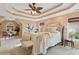 Spacious main bedroom with tray ceiling, neutral tones, and sitting area with backyard views at 230 Bluff Oak Dr, Roswell, GA 30076